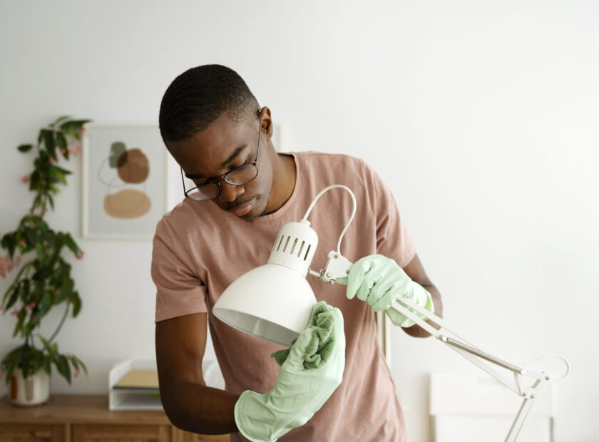 medium-shot-man-servant-cleaning-lamp