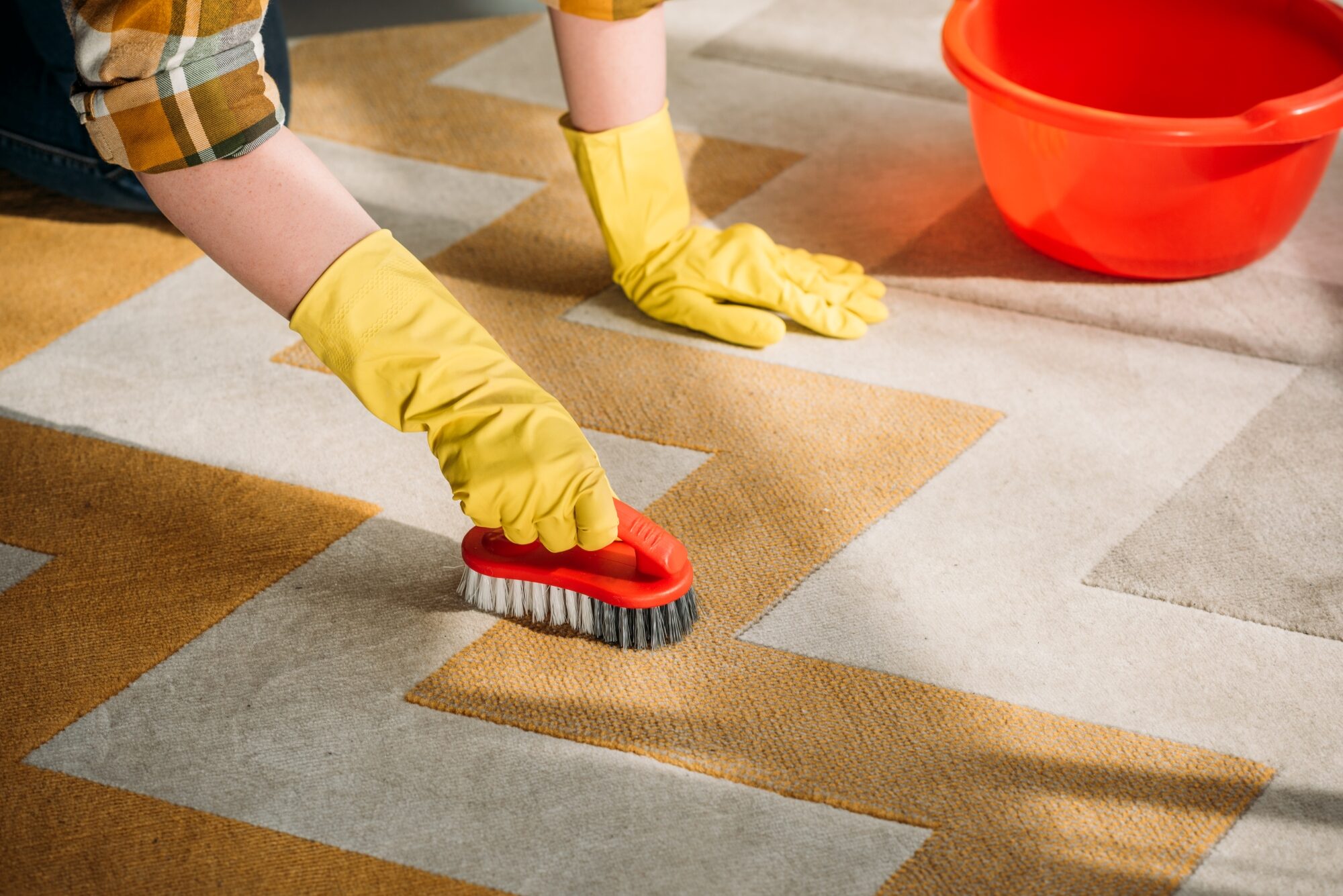 cropped-image-of-woman-cleaning-carpet-at
